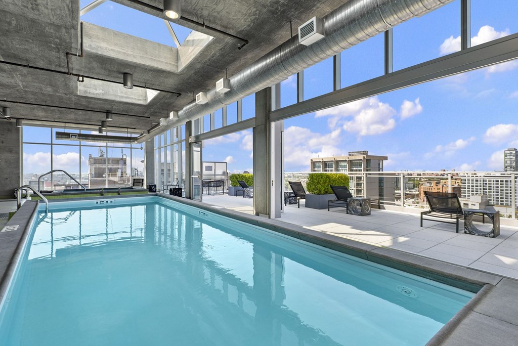 a swimming pool with large windows and a city view