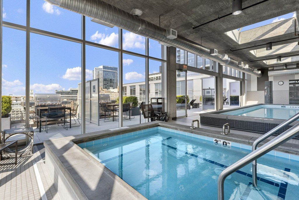 a swimming pool with a view of a city in front of a window