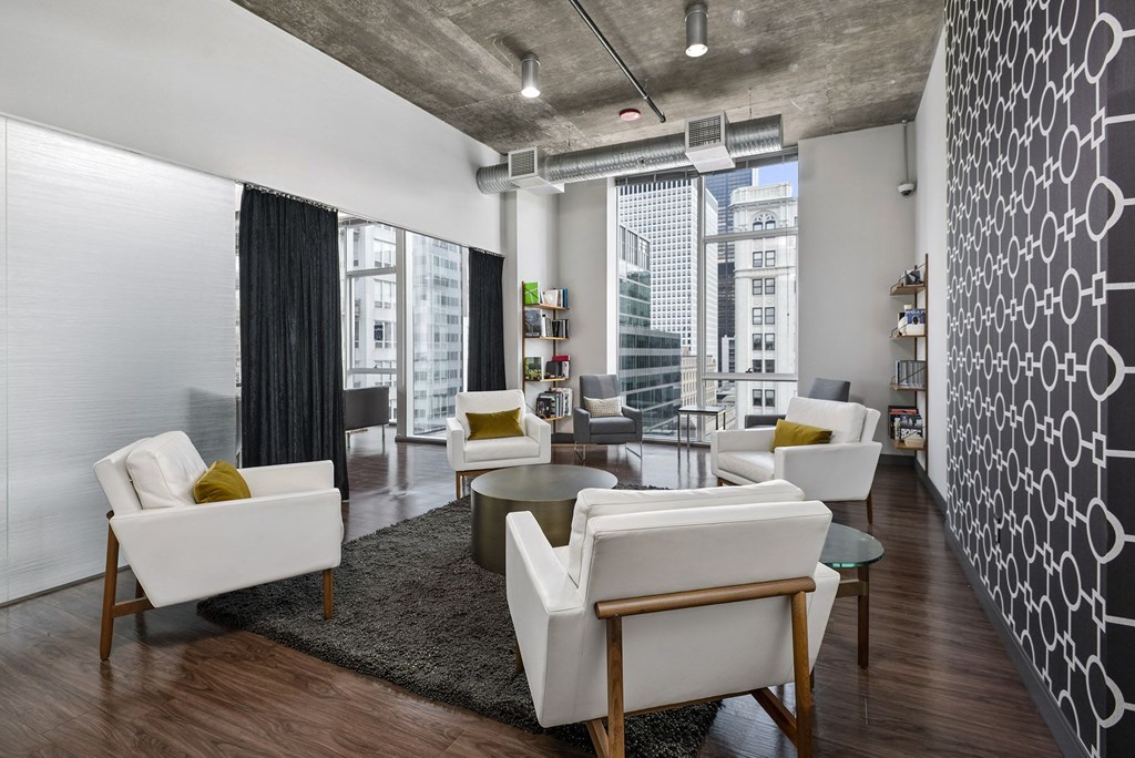 a living room with white furniture and a large window