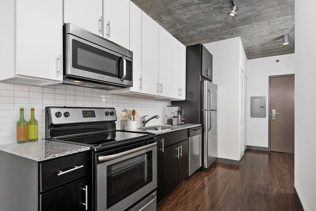 a kitchen with black appliances and white cabinets