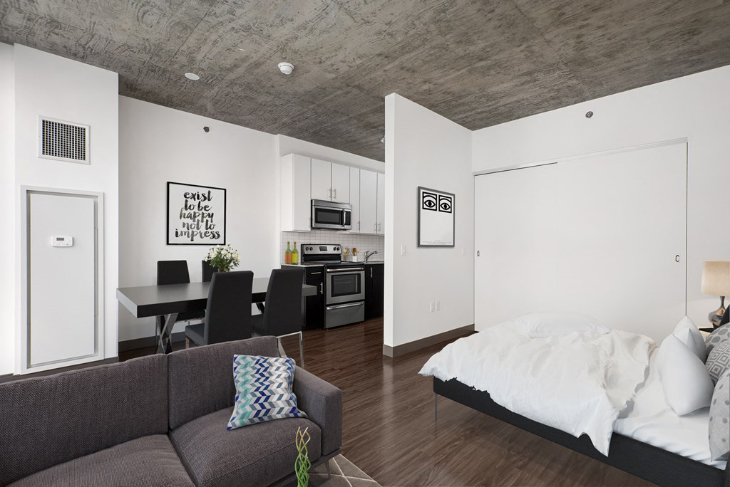 a bedroom and living room with a couch and a bed