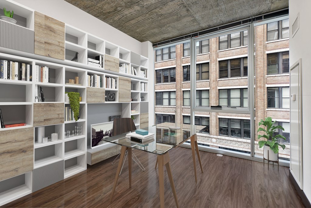 a living room with a glass table and a bookshelf