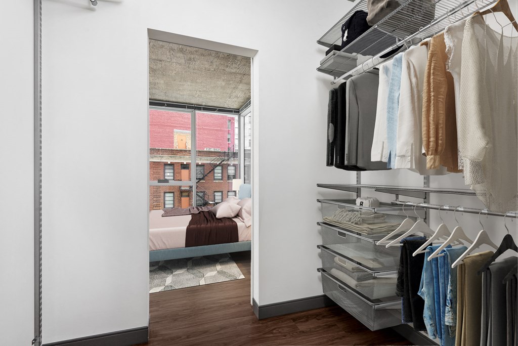 a closet with a window and a door to a bedroom