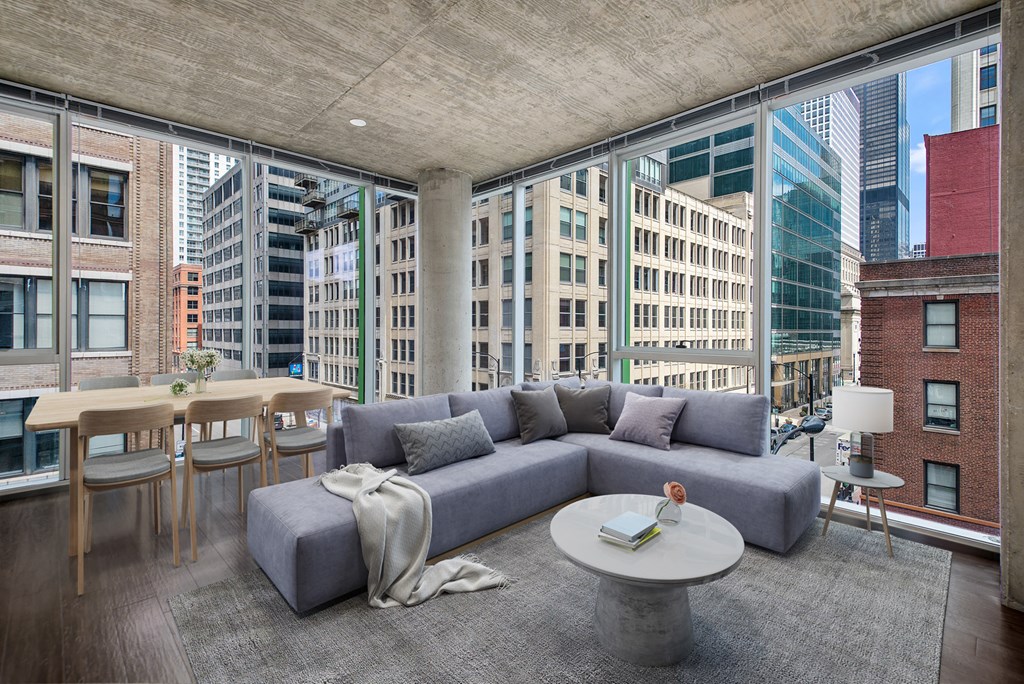 a living room with a gray couch and a table