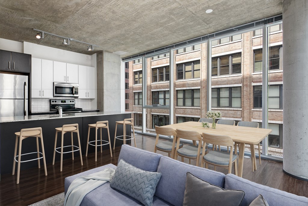 a living room with a kitchen and a dining table