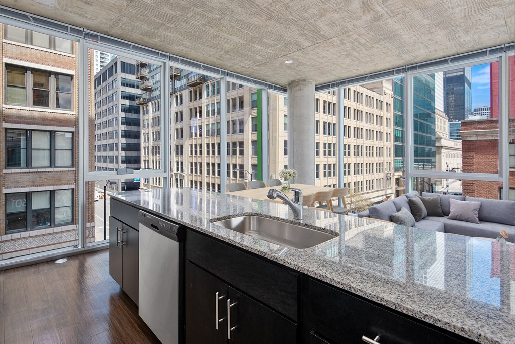 a kitchen with a large counter and a view of a city