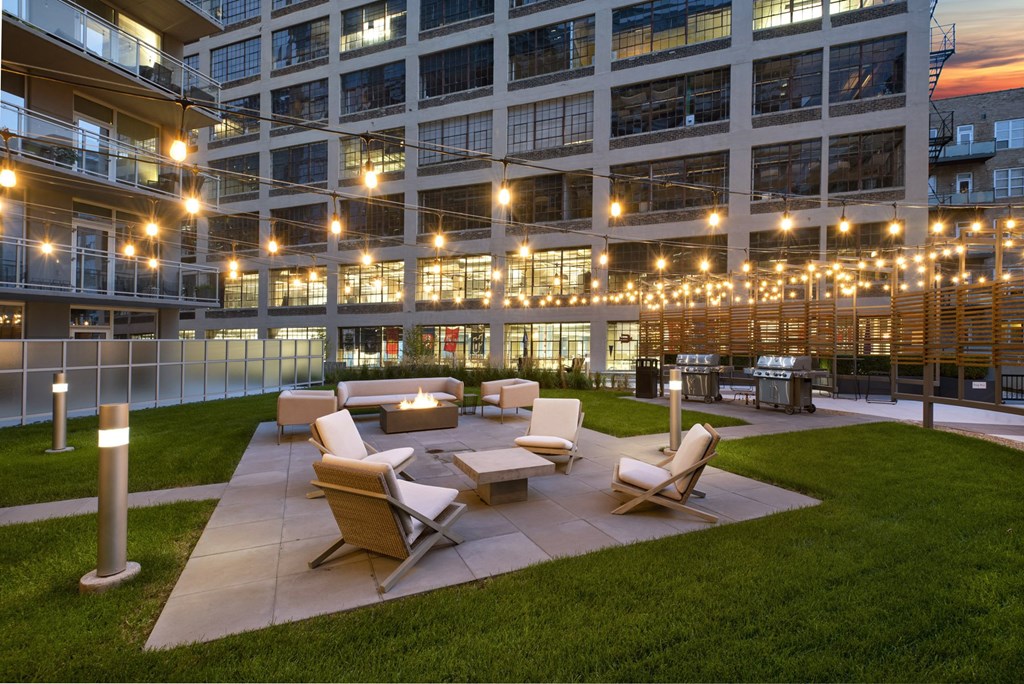 a courtyard with furniture and lights in an office building
