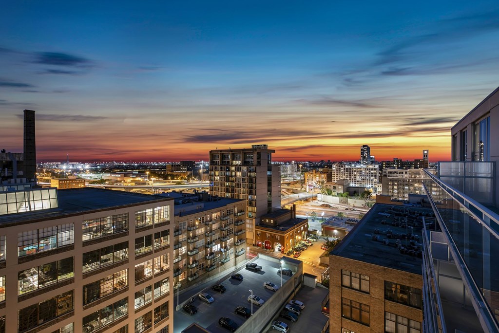 a view of the city at sunset from a high rise building