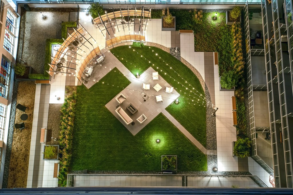 a birds eye view of the courtyard of a building with a lawn