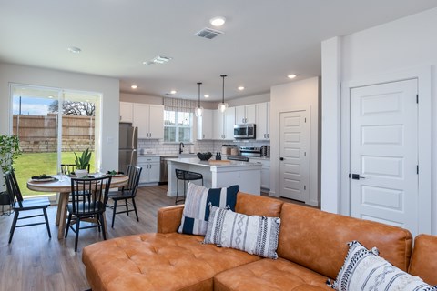 A modern kitchen with a dining table and chairs.