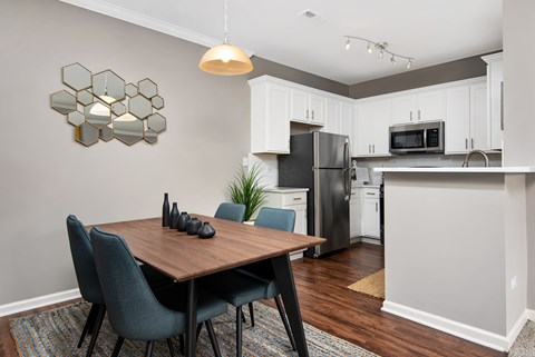 a kitchen and dining room with a table and chairs