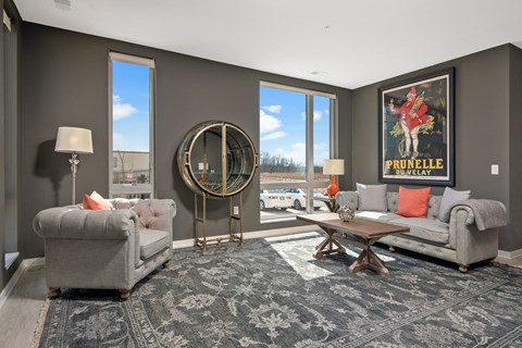 a living room with couches and chairs and a rug