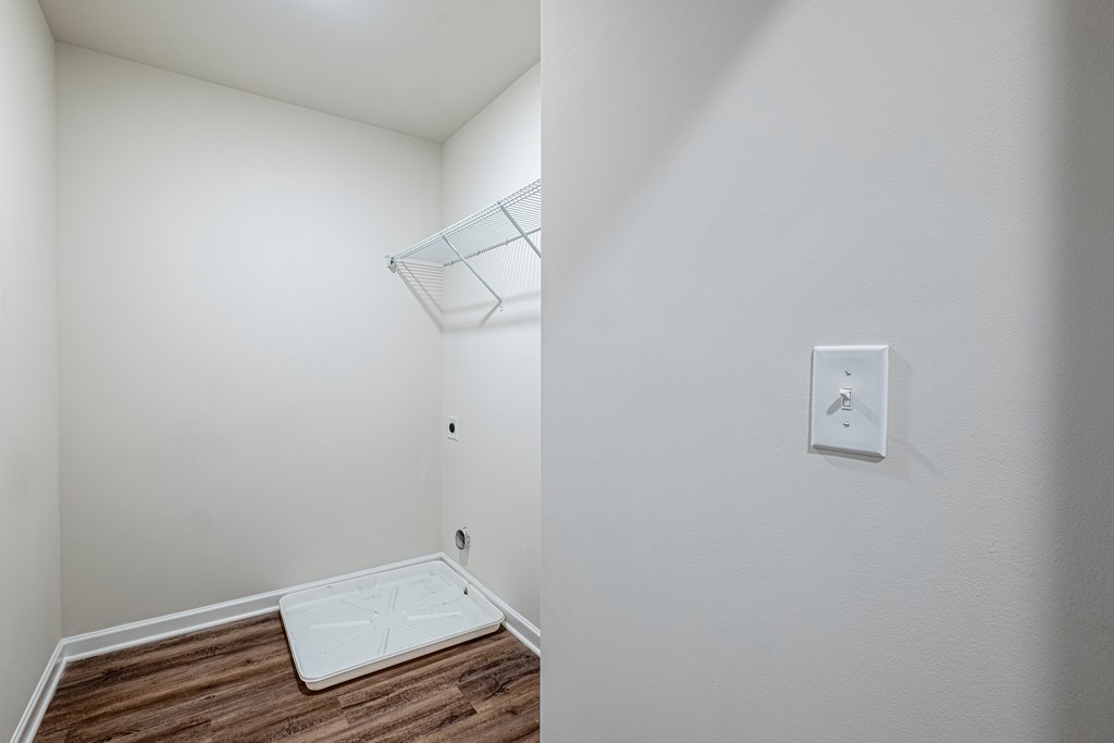 room with white walls and wood flooring and a white closet