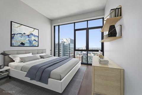 a bedroom with a bed and a large window