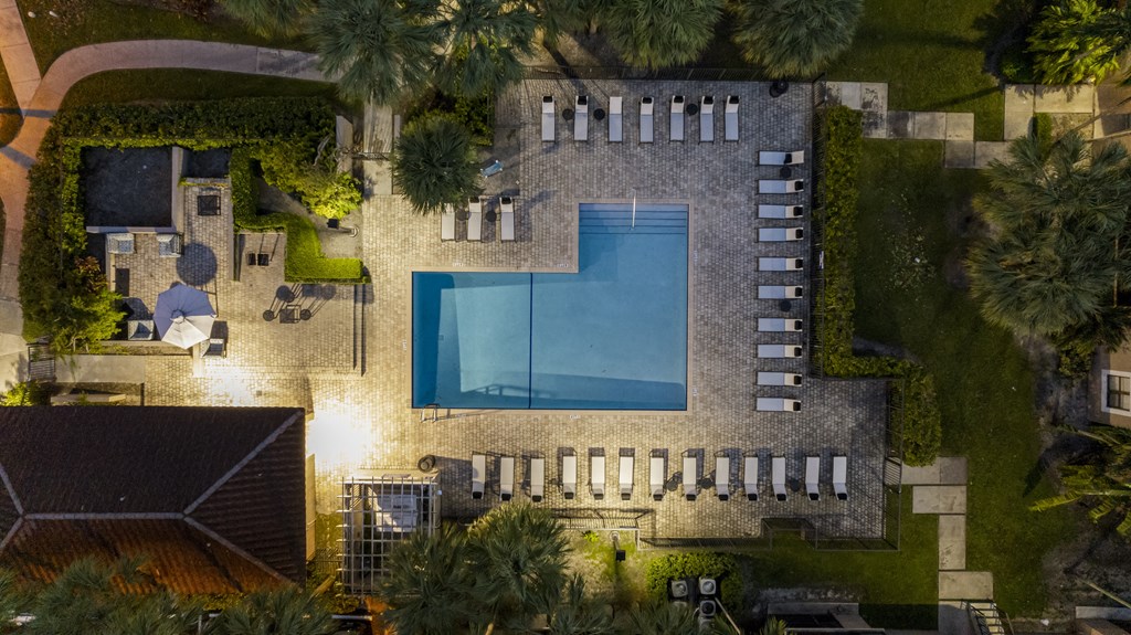 a birdseye view of the backyard of a house with a pool