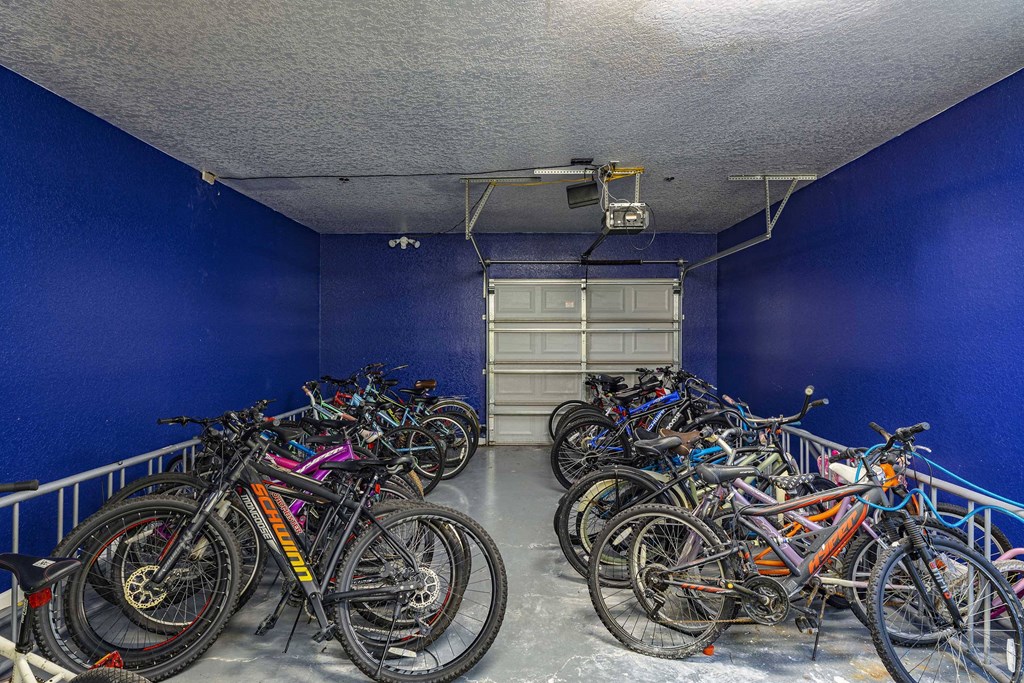 a bunch of bikes parked in a blue room