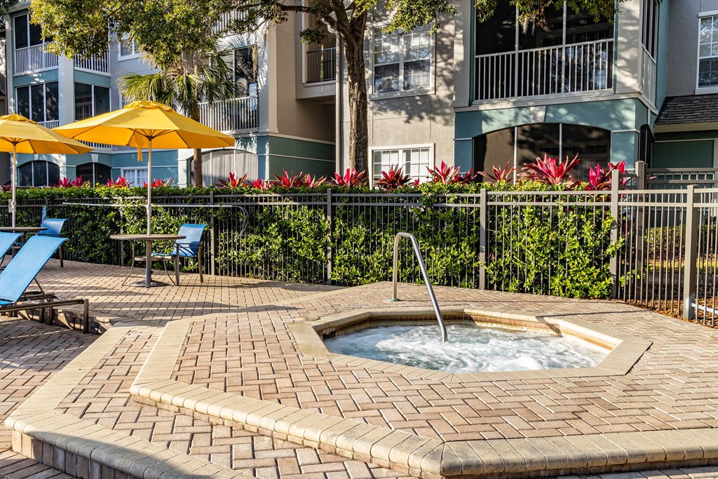 a jacuzzi in a courtyard with an apartment building in the background