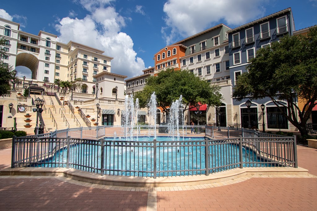 a fountain in the middle of a city street with buildings