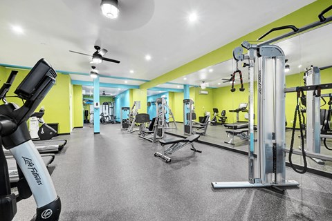 A gym with a variety of equipment including a leg press machine.