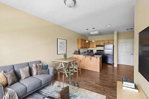 A living room with a grey couch and a wooden table.