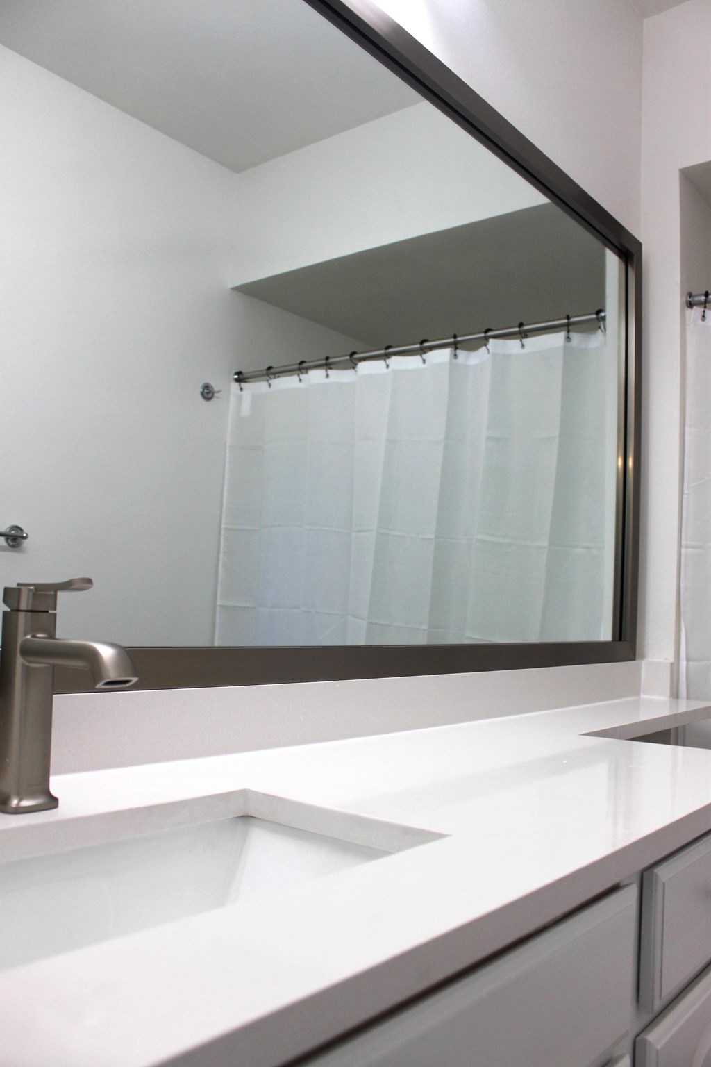 a bathroom with a sink and a large mirror