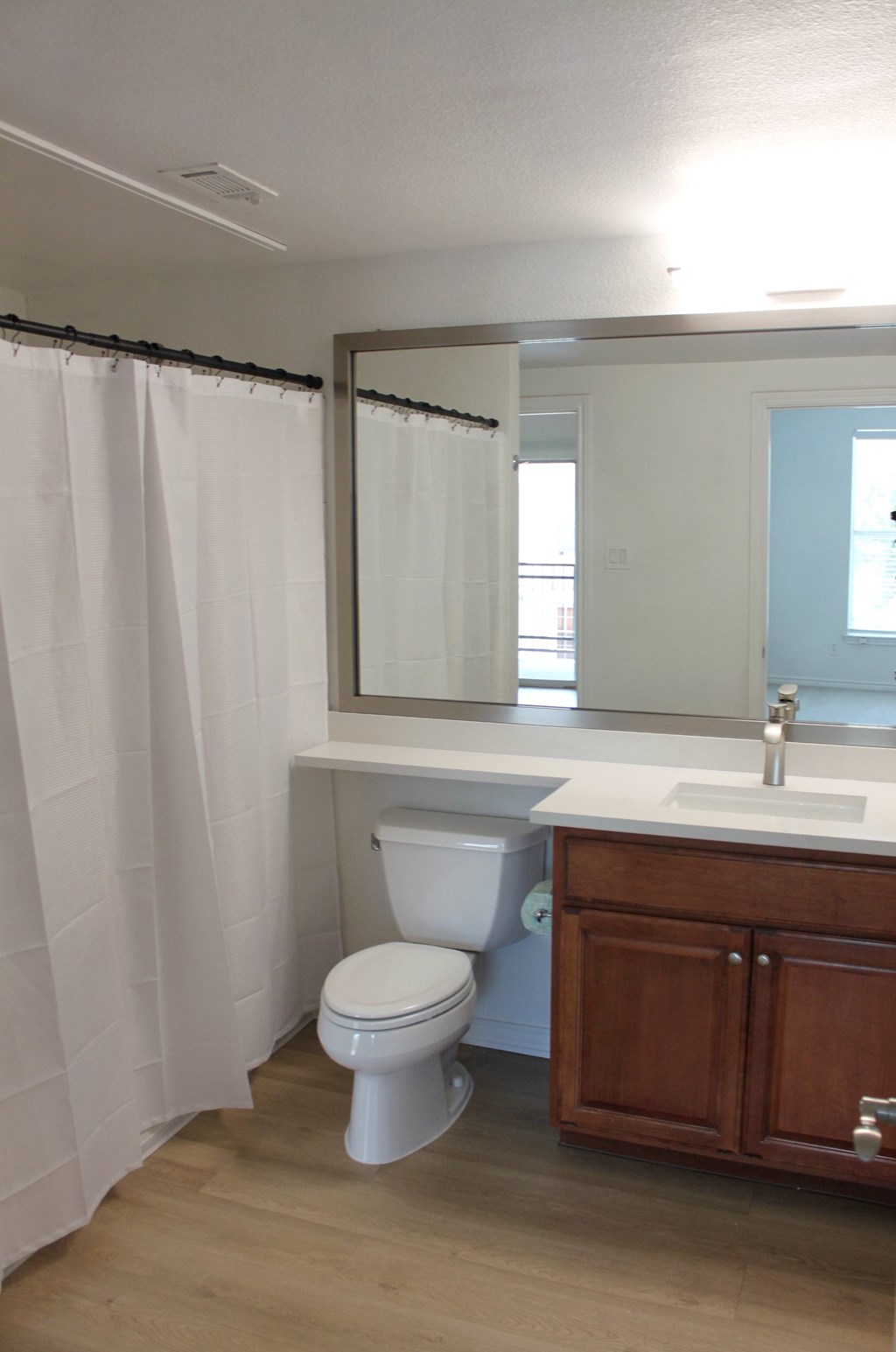 a bathroom with a toilet and a sink and a mirror