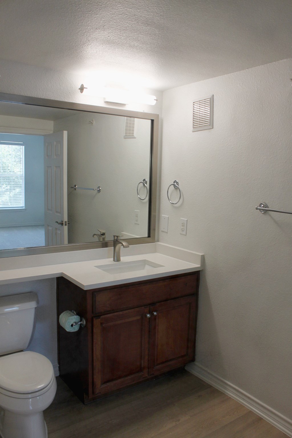 a bathroom with a toilet and a sink and a mirror