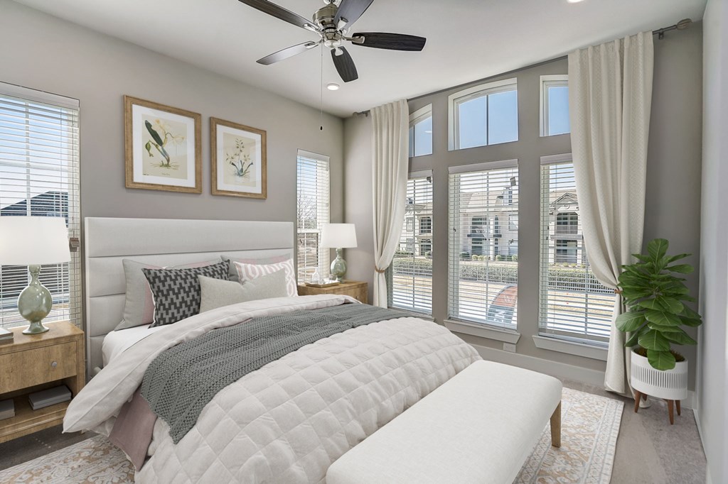 a bedroom with a bed and a ceiling fan