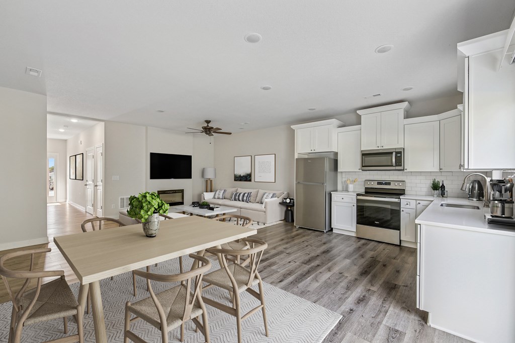 A modern kitchen with a dining table and chairs.