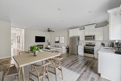 A modern kitchen with a dining table and chairs.