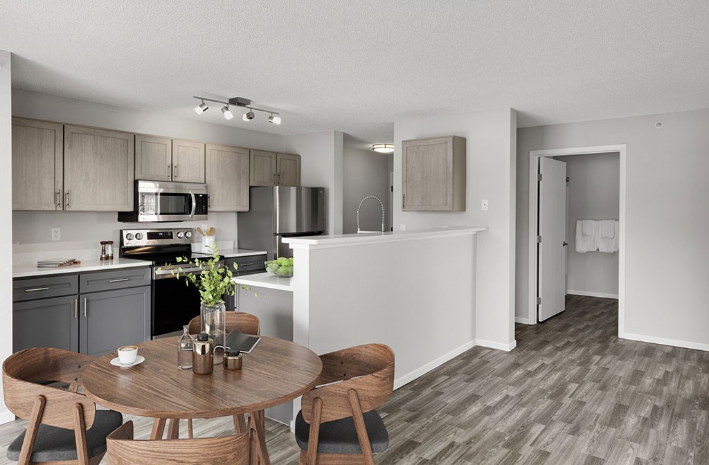 an open kitchen and dining room with a wooden table