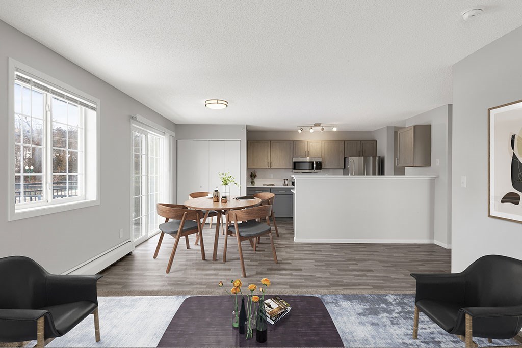 a living room and kitchen with a table and chairs