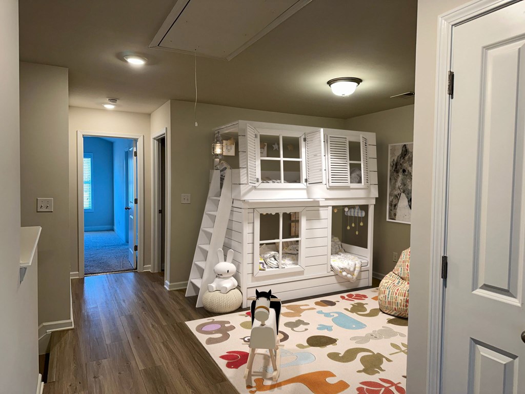 a childrens play room with a white bunk bed