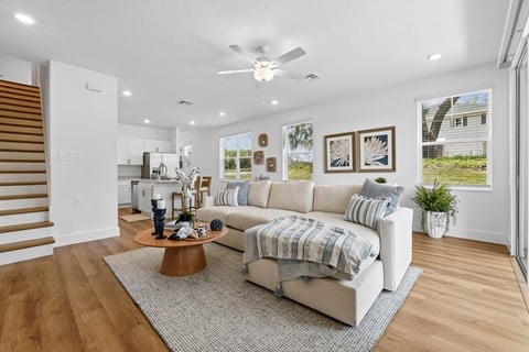 A living room with a white couch and a coffee table.
