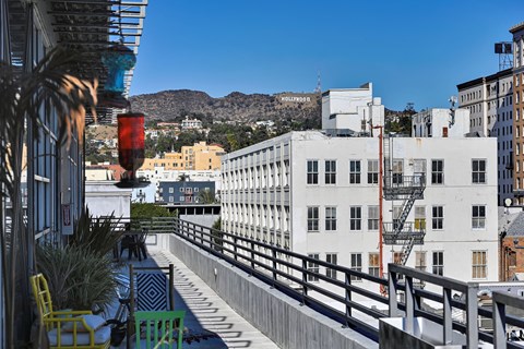 A white building with a red traffic light in front of it.