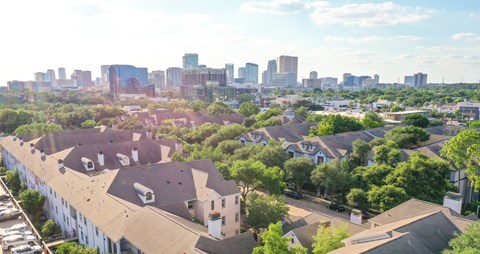 A cityscape with a row of houses in the foreground.