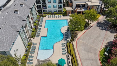 A large swimming pool surrounded by apartment buildings.