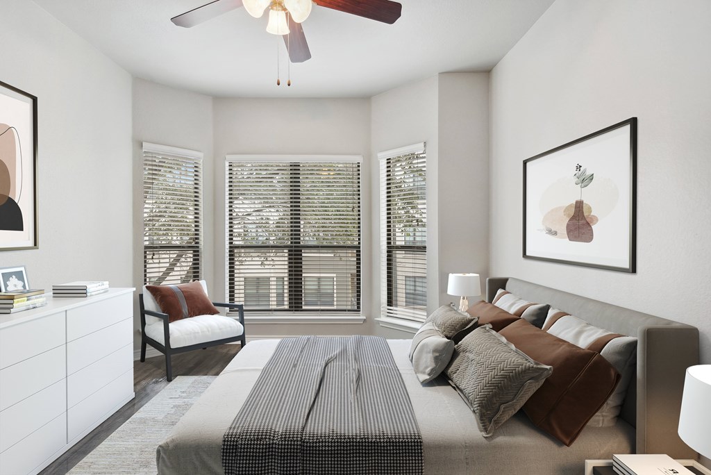 a bedroom with a large bed and a ceiling fan