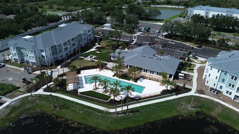 An aerial view of a resort with a swimming pool.