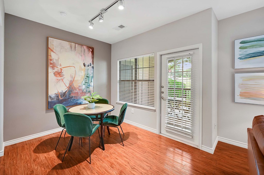 a dining room with a table and chairs and a window