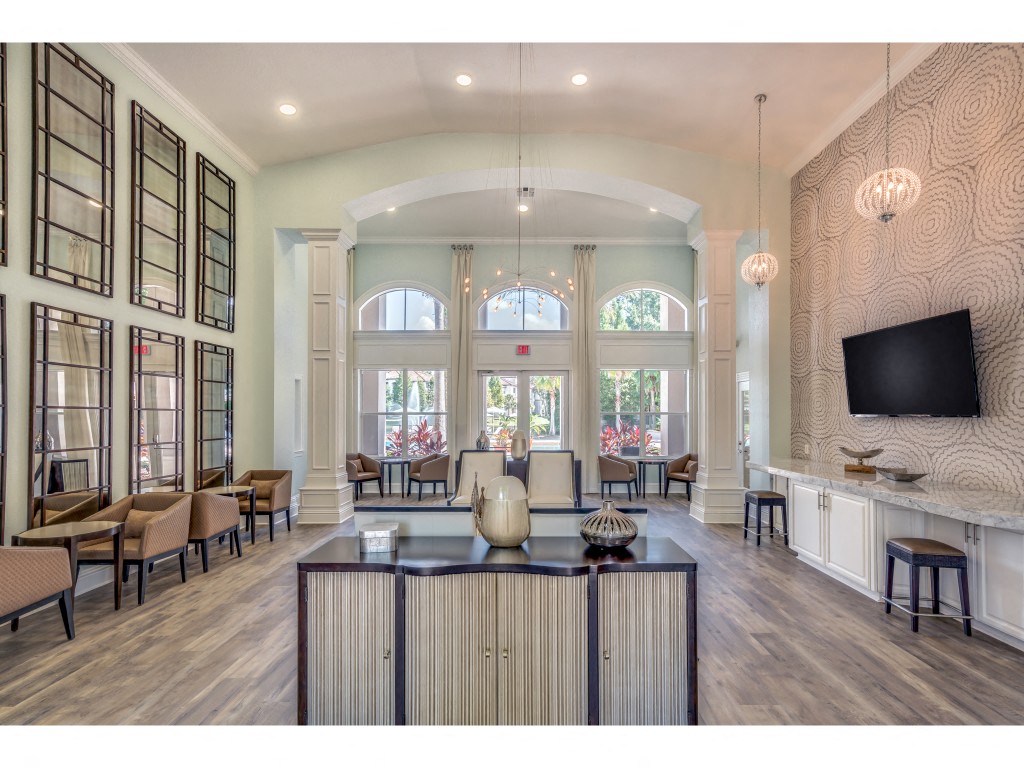 a living room with large windows and a tv