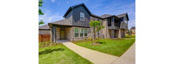 an exterior view of a house with a sidewalk and grass