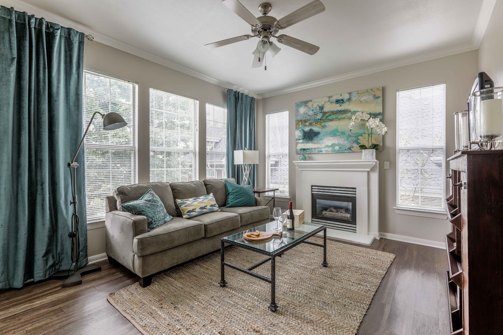 a living room with a couch and a ceiling fan