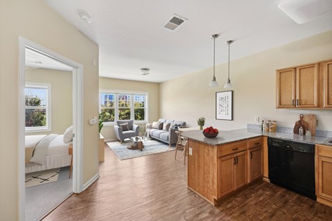 A kitchen with wooden cabinets and a black dishwasher.