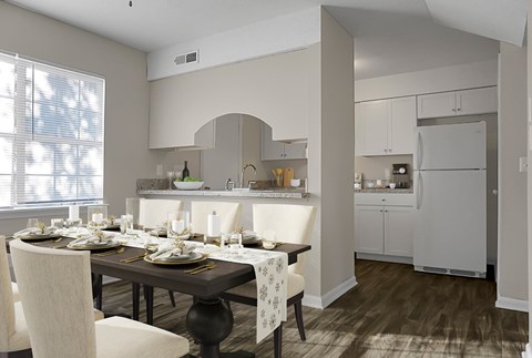 A modern kitchen with a dining table set for a meal.