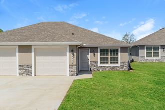 a house with a gray roof and a green lawn