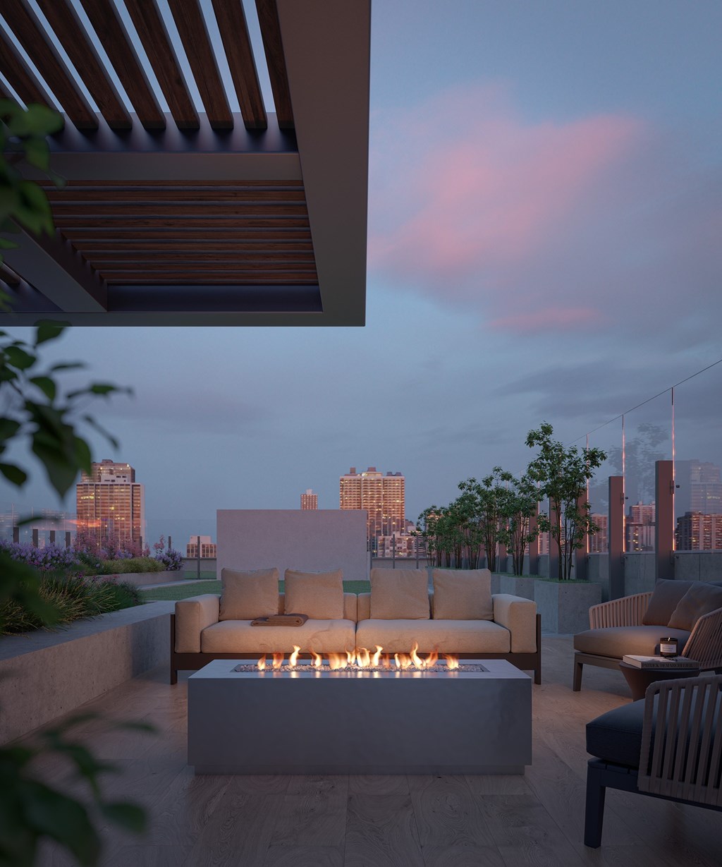 Luxury Apartments In Chicago, IL For Rent - Outdoor Private Terrace With Firepit, Cozy Chairs, Maintained Landscaping, And City Views.