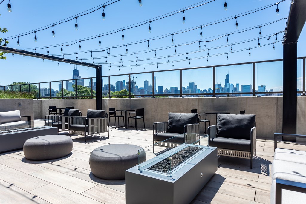 Old Town, Chicago, IL Apartments - North + Vine - Rooftop Lounge With Plush Chairs, Gas Fireplaces, String Lighting, And Amazing Views Of The City.