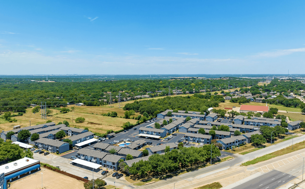 an aerial view of a city with many houses and trees