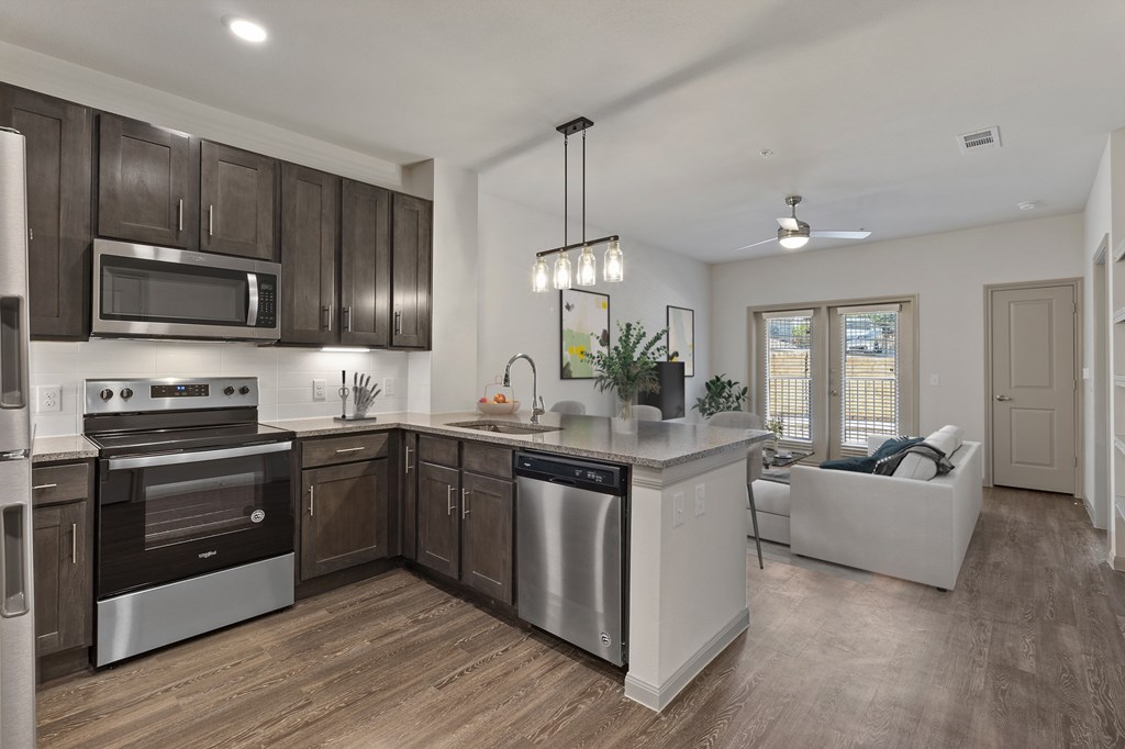 an open kitchen and living room with a large counter top